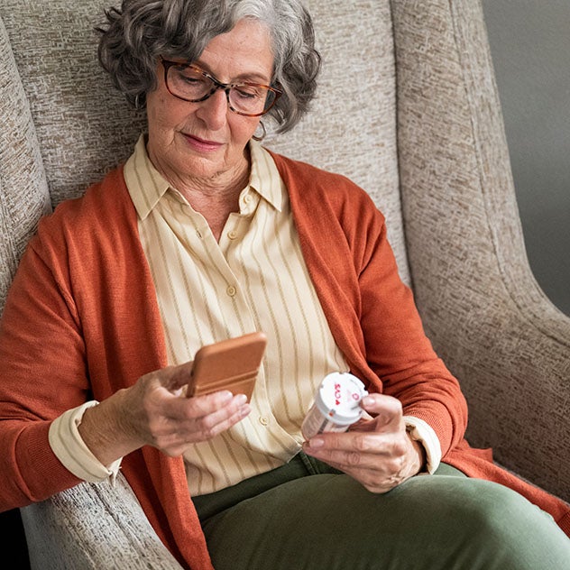 Woman refilling CVS prescription on cellphone
