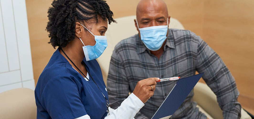 Nurse and patient reviewing information together