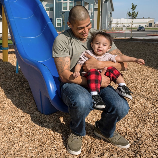 Father and son on slide at playground