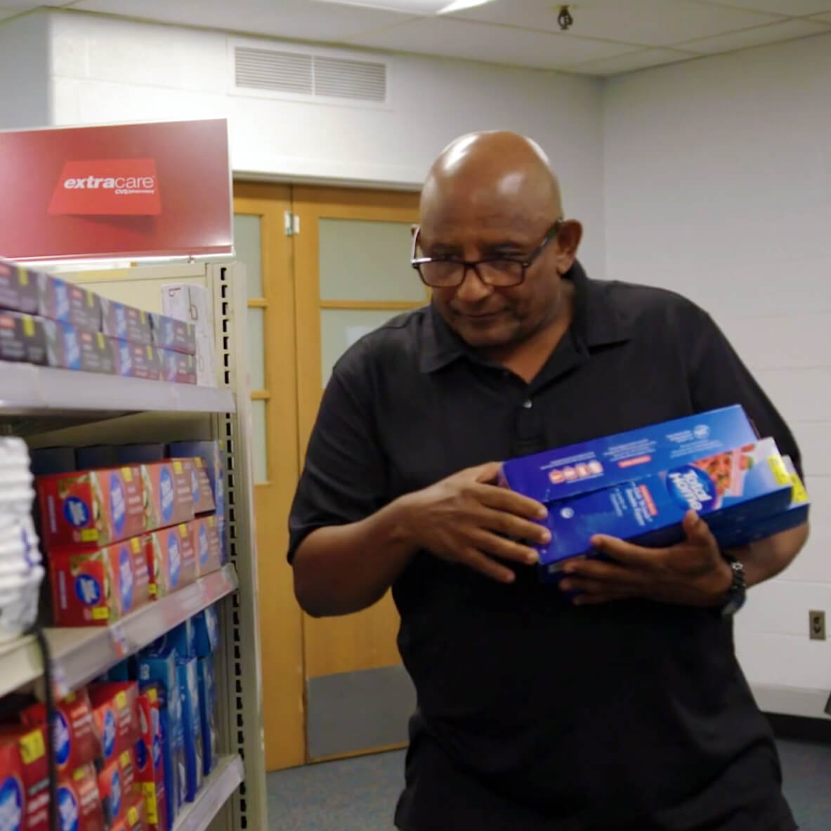 A participant in our Abilities In Abundance stocks shelves in one of our training centers.