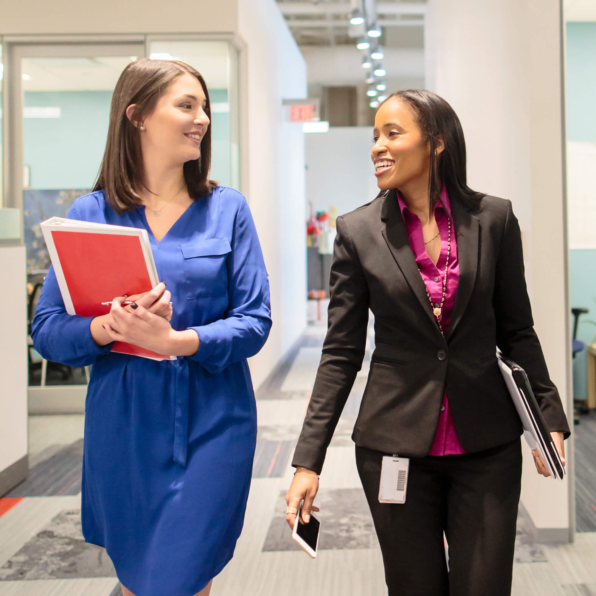Two female CVS Health colleagues walking down a corridor.