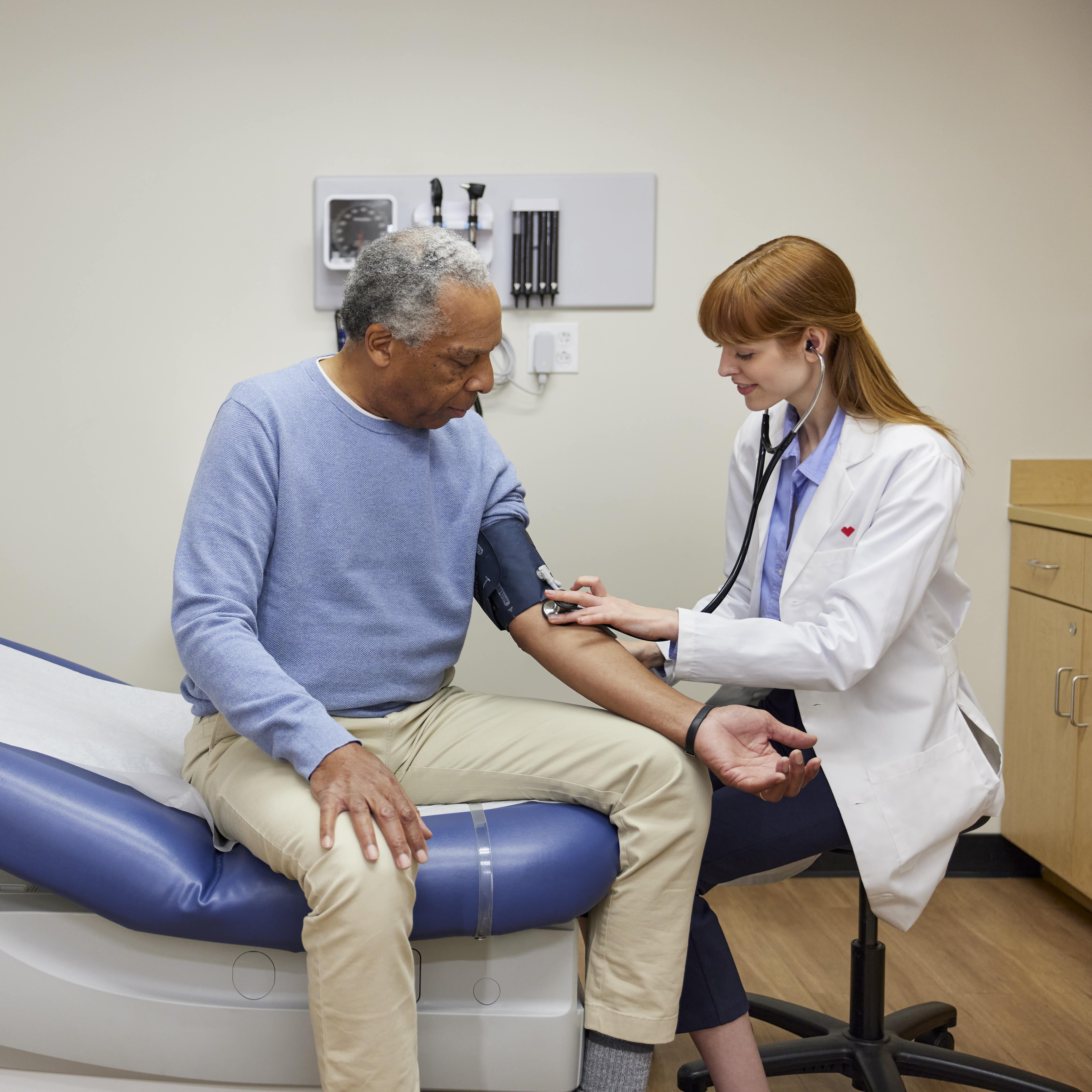 A doctor taking a patient's blood pressure