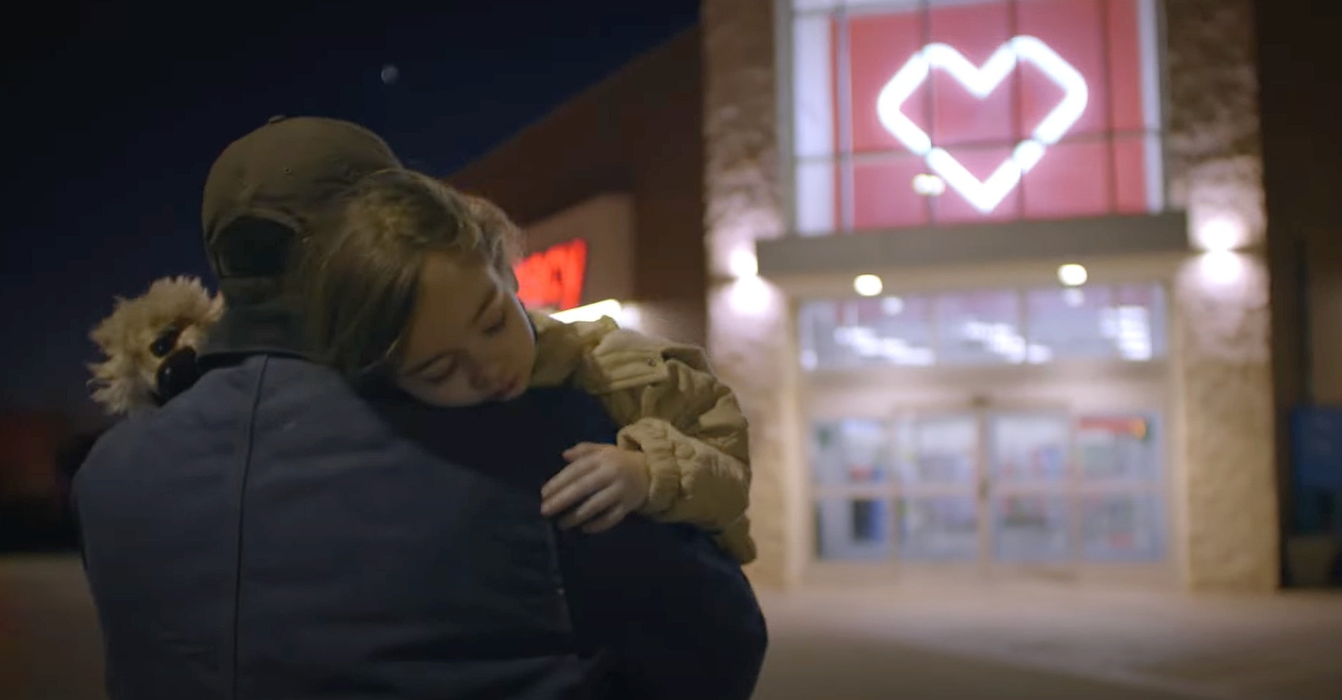 A father carrying sick daughter into CVS Pharmacy