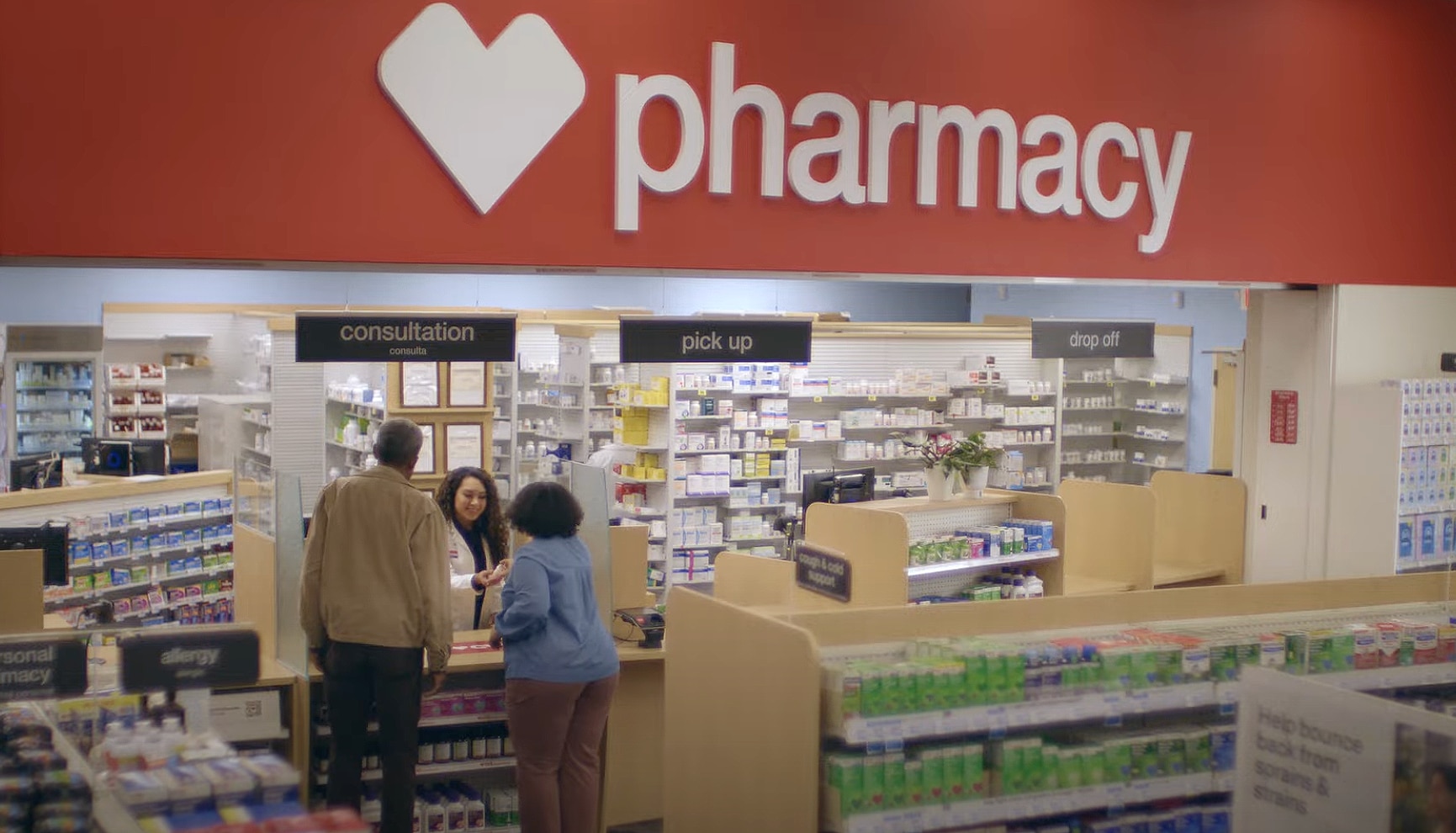 two customers at the pharmacy counter at CVS