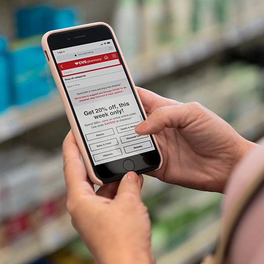 Customer holding their cellphone in a CVS store