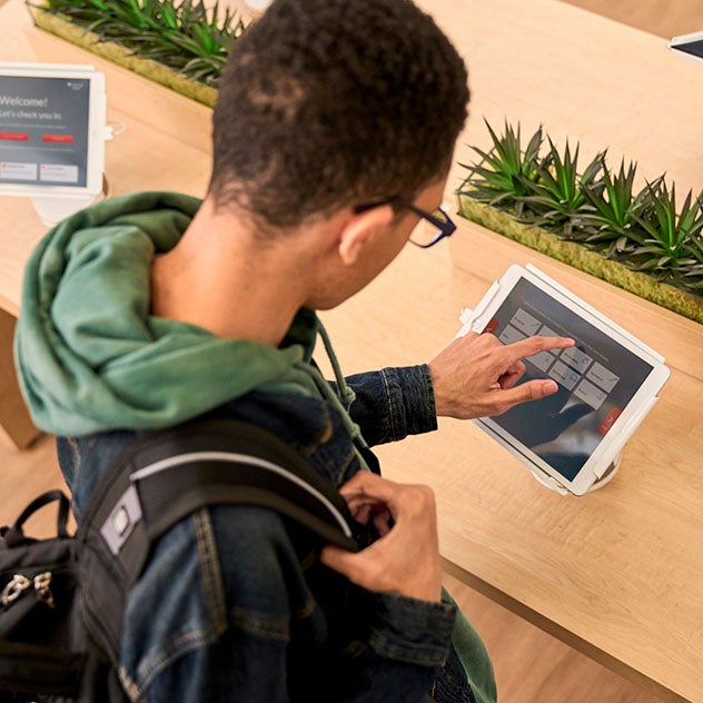 A young adult using an iPad