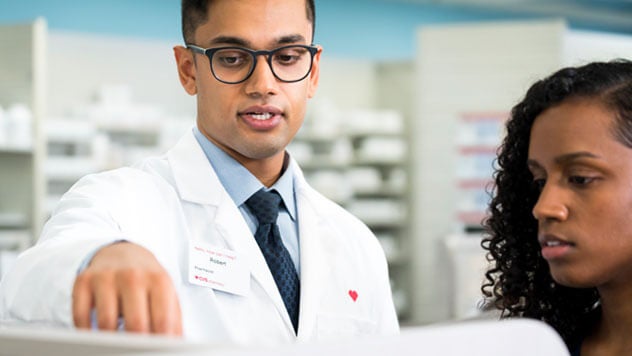 Male and female pharmacists working together in pharmacy