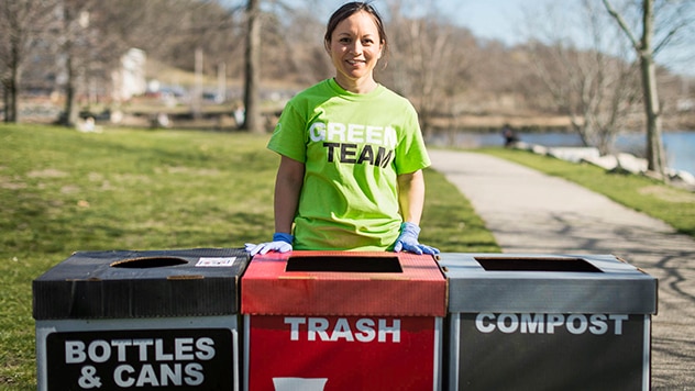 CVS Green Team member smiling behind a trash can