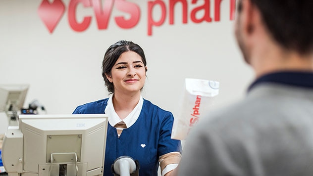 CVS pharmacist talking to male patient