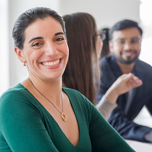 A women smiling in a meeting