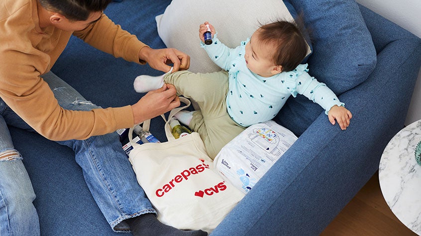 A father dressing his young child