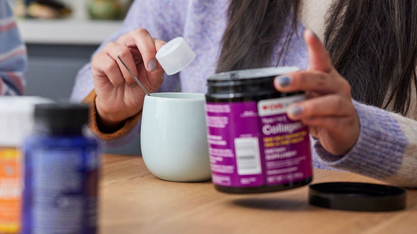 Two women sitting at a table with vitamins