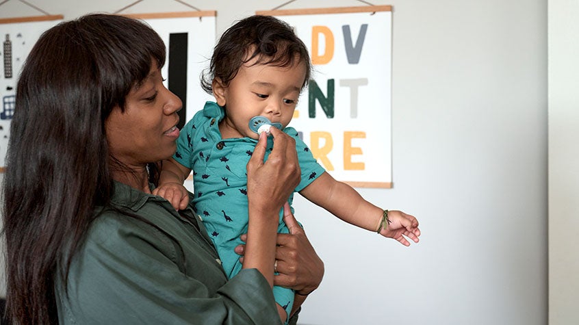 Mother giving her baby a pacifier