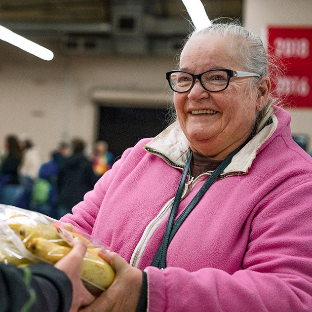 A woman holding a bunch of bananas