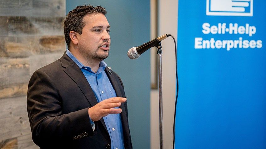 Man giving a speech into a microphone