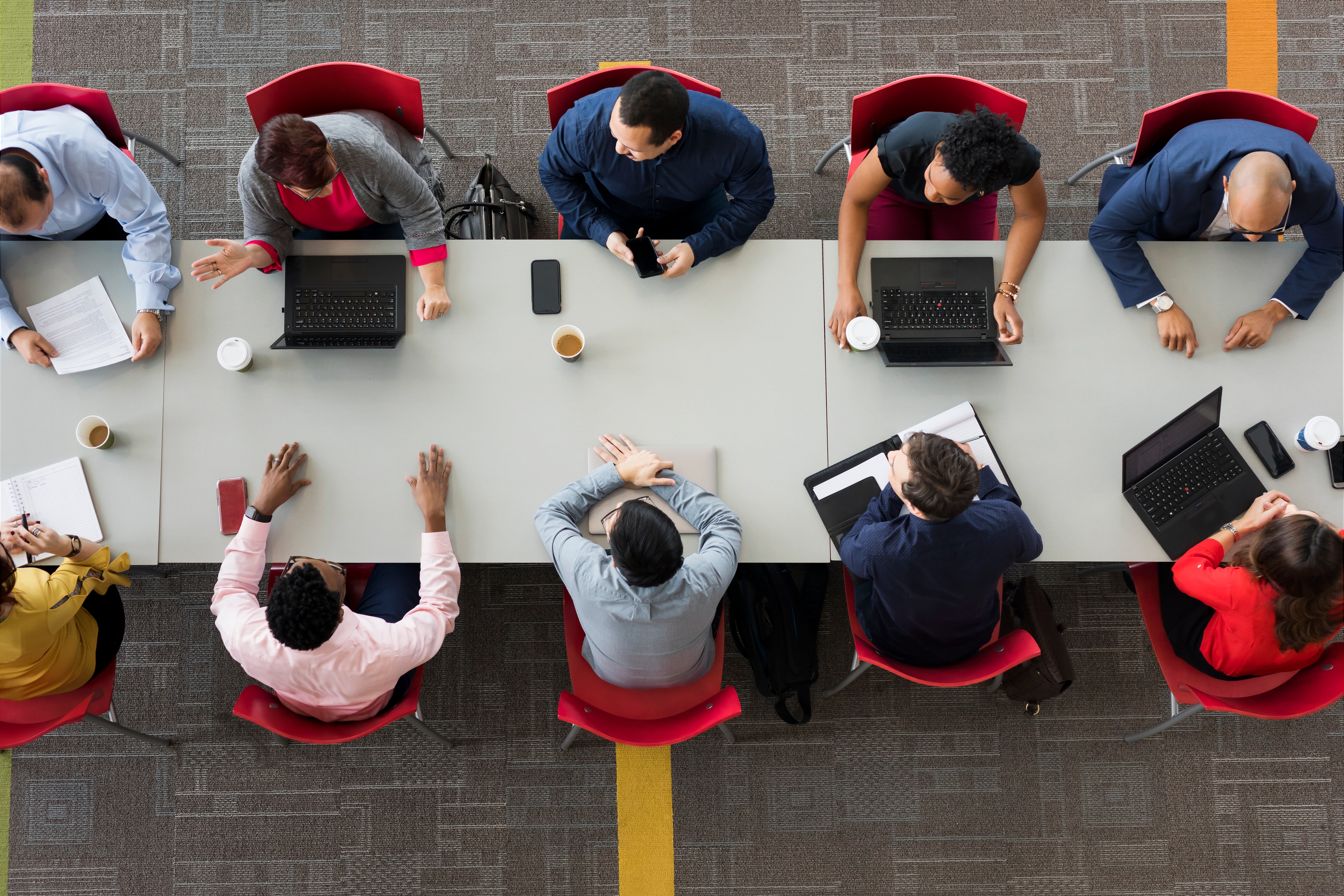 Overhead view of a group of colleagues sitting around a conference table