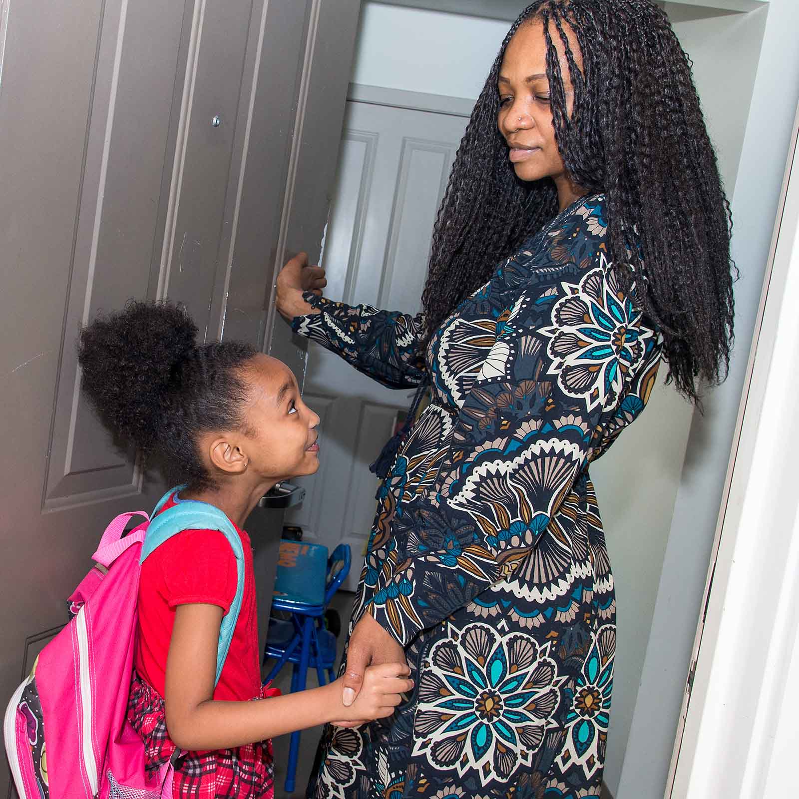 A mother and daughter seen entering their home.