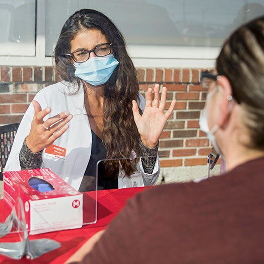Two CVS pharmacists sitting at a table