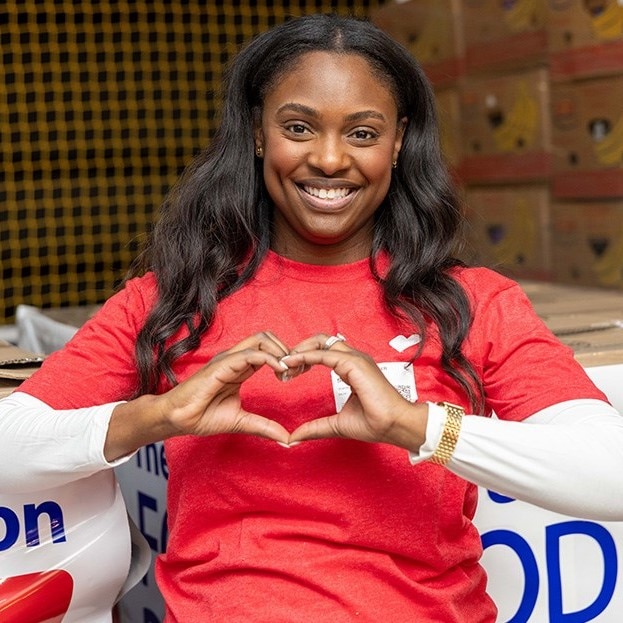 A woman forming a heart shape with her hands