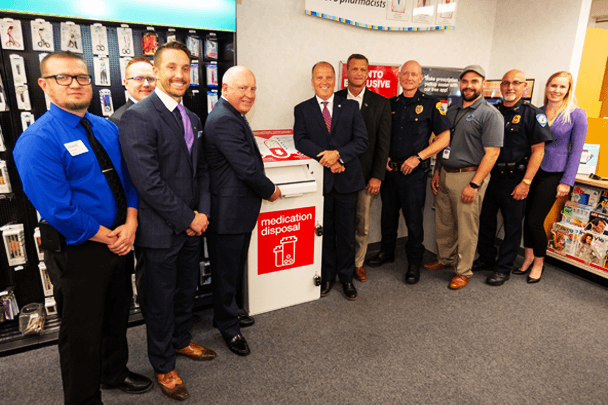 Officials and colleagues celebrate the Wisconsin program expansion.