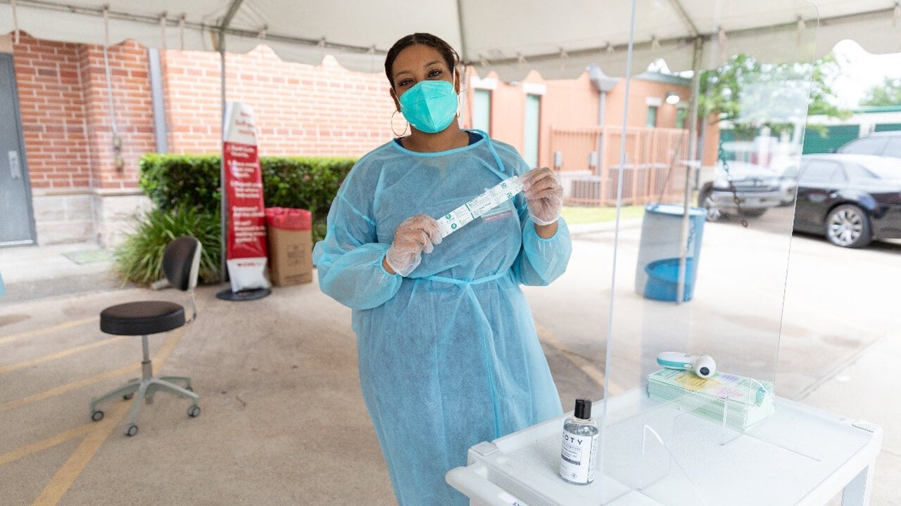 CVS Testing Center associate with swabs