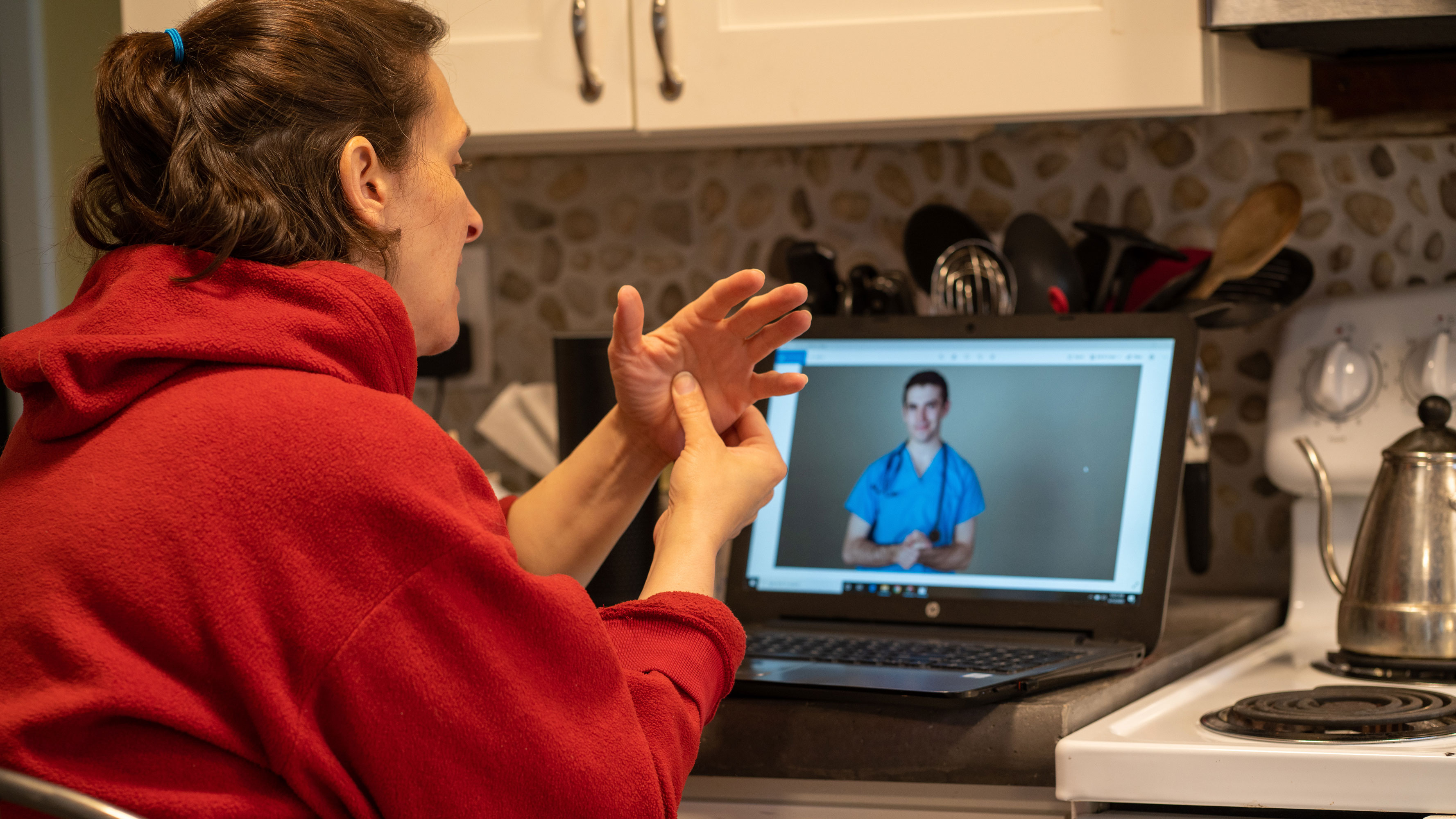 Online Telehealth visit with a woman who hurt her hand in the kitchen.