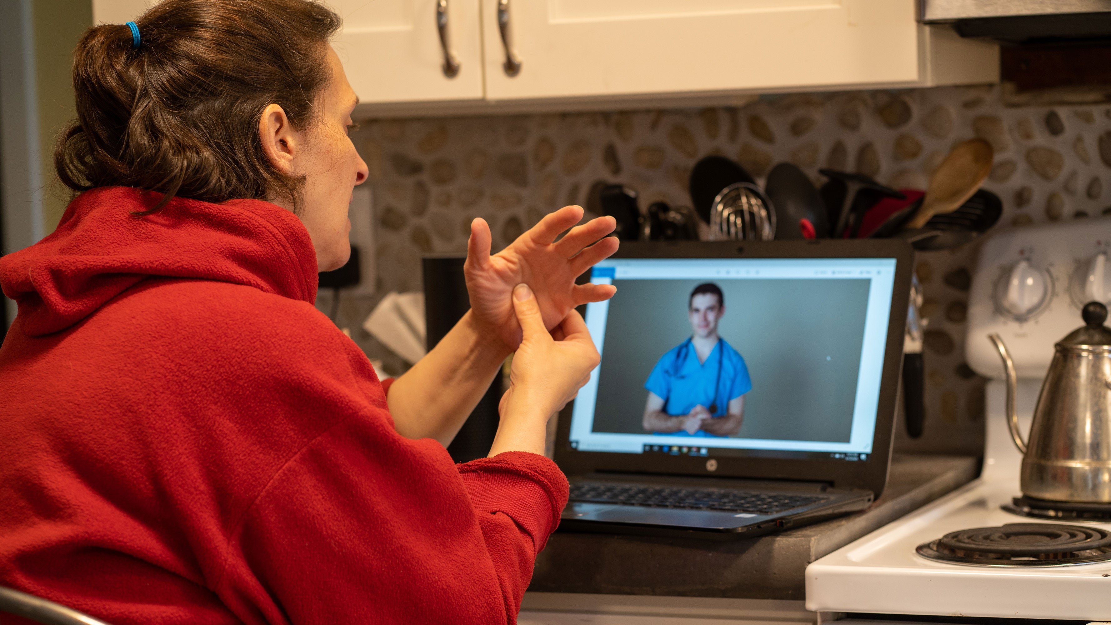 Online Telehealth visit with a woman who hurt her hand in the kitchen.