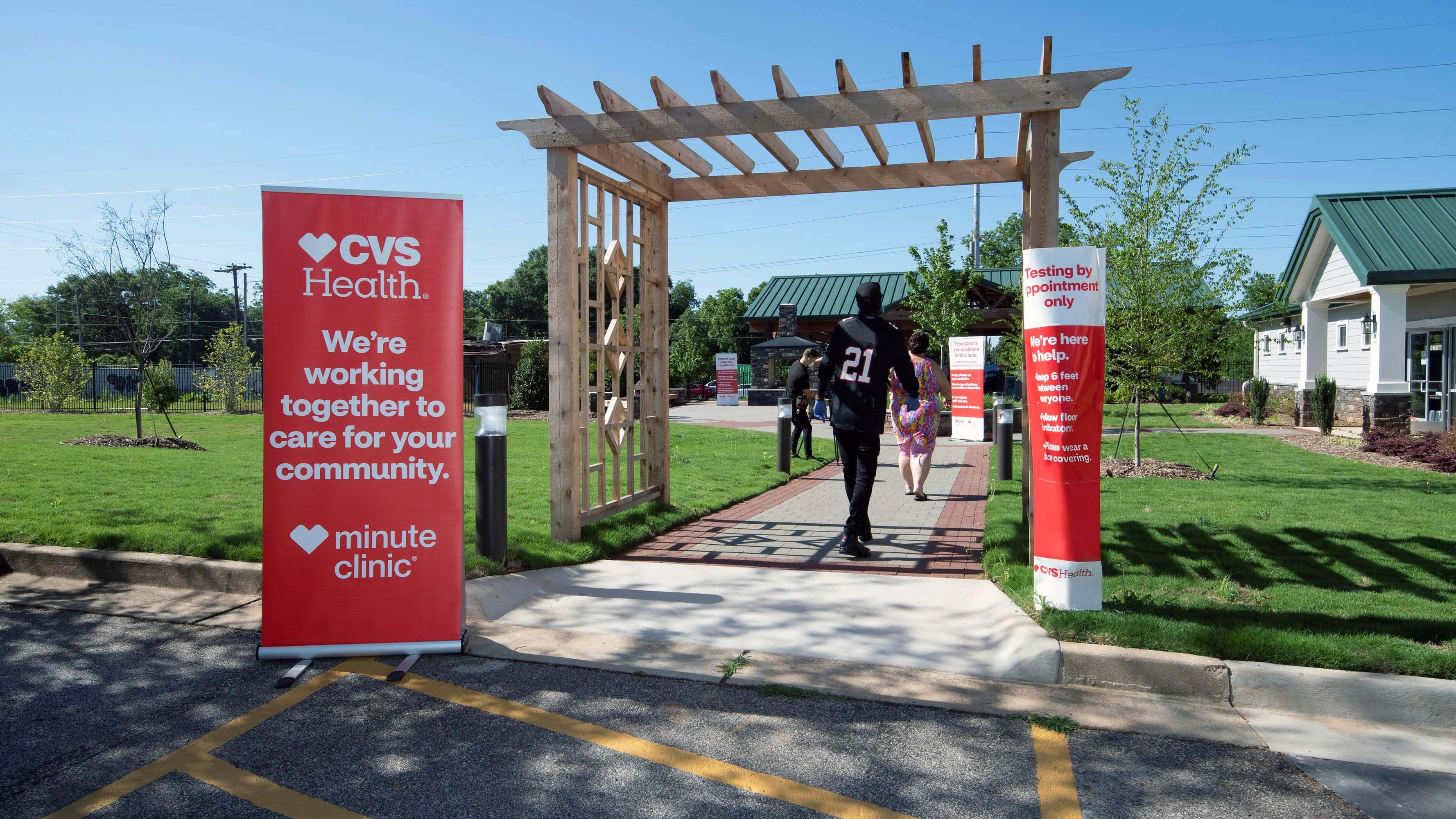 Several people walking into a CVS Health community test center in Atlanta, Georgia.