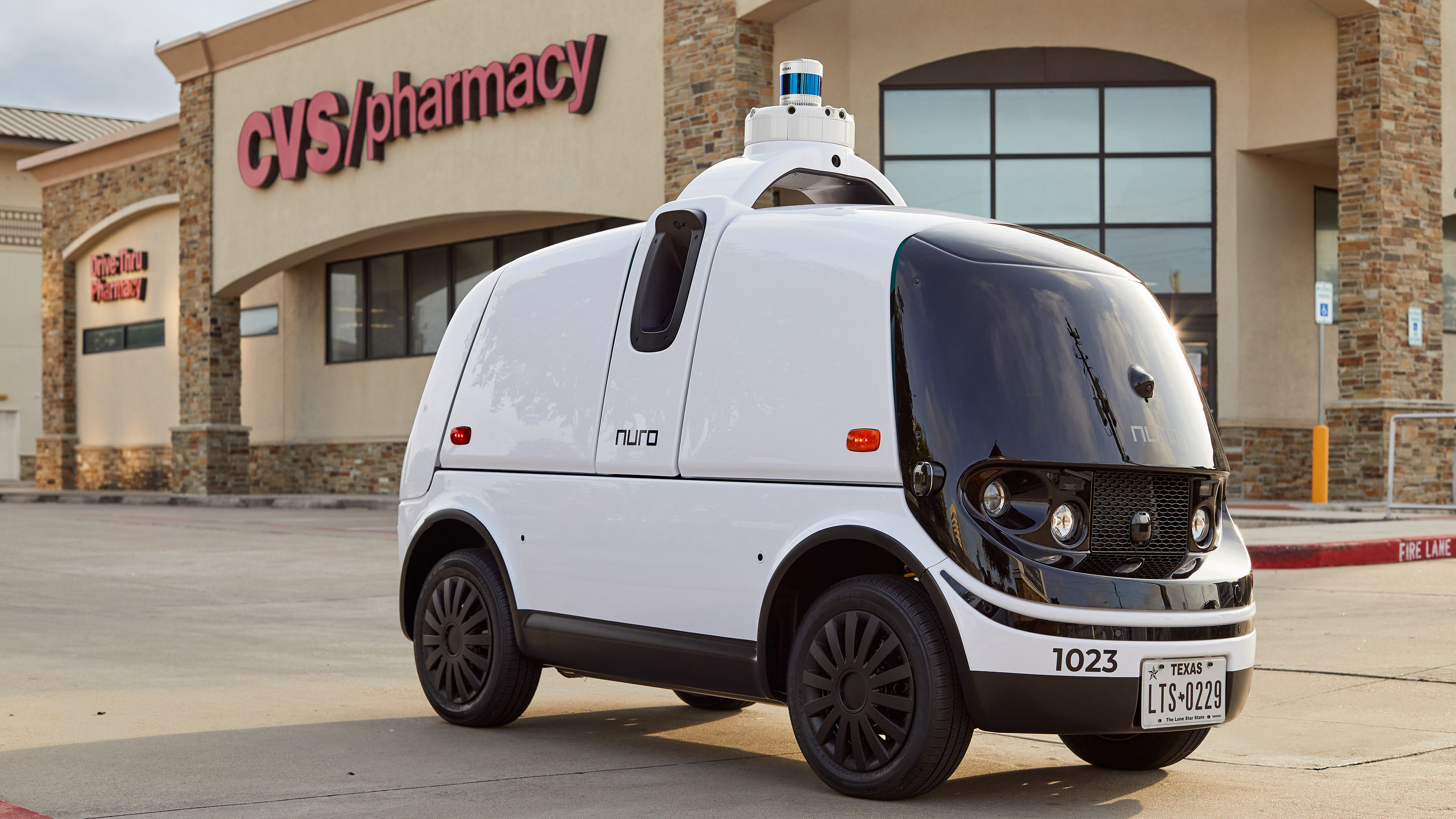 A Nuro autonomous vehicle is parked outside of a CVS Pharmacy location in Texas.