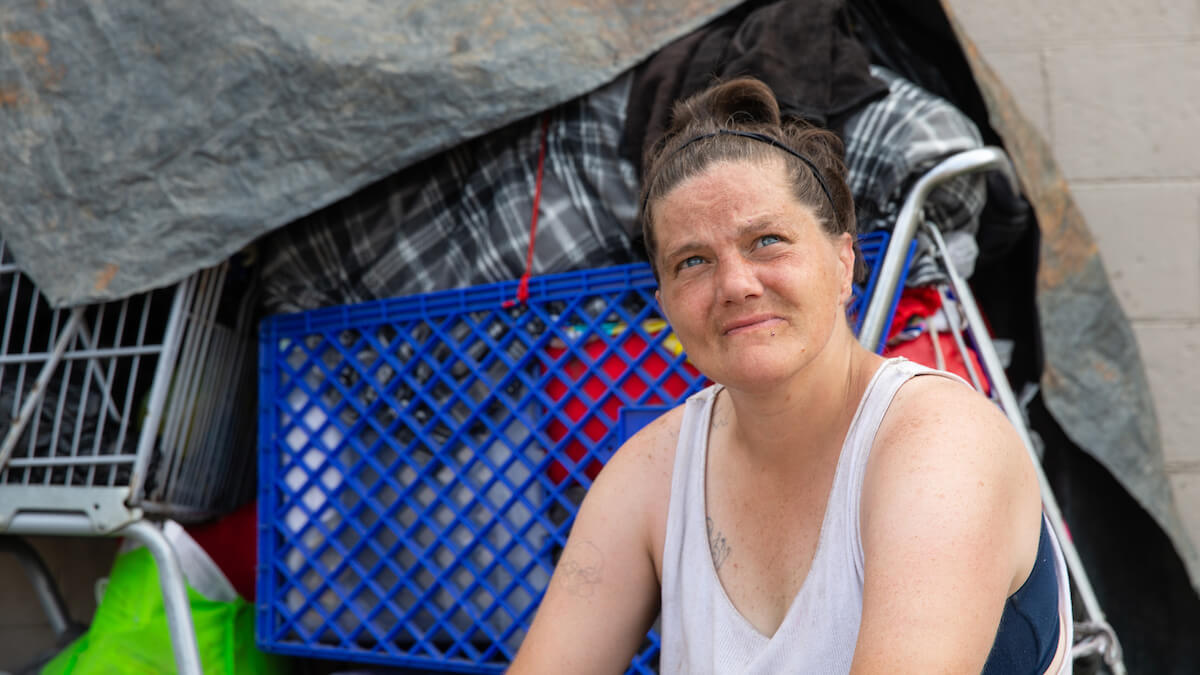 Amanda sits in the parking lot outside the United Way Drop-in Peer Center in Charleston, West Virginia.