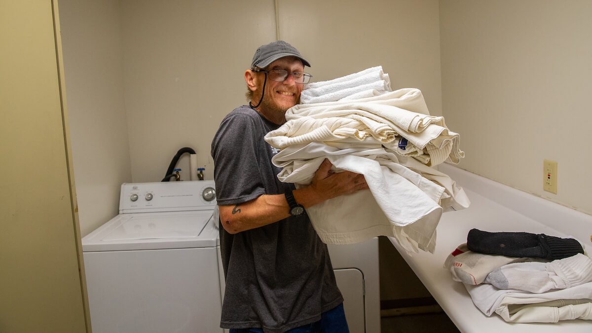 William Turley does his laundry inside the Peer Center (a drop-in center for individuals experiencing homelessness) in Charleston, West Virginia.
