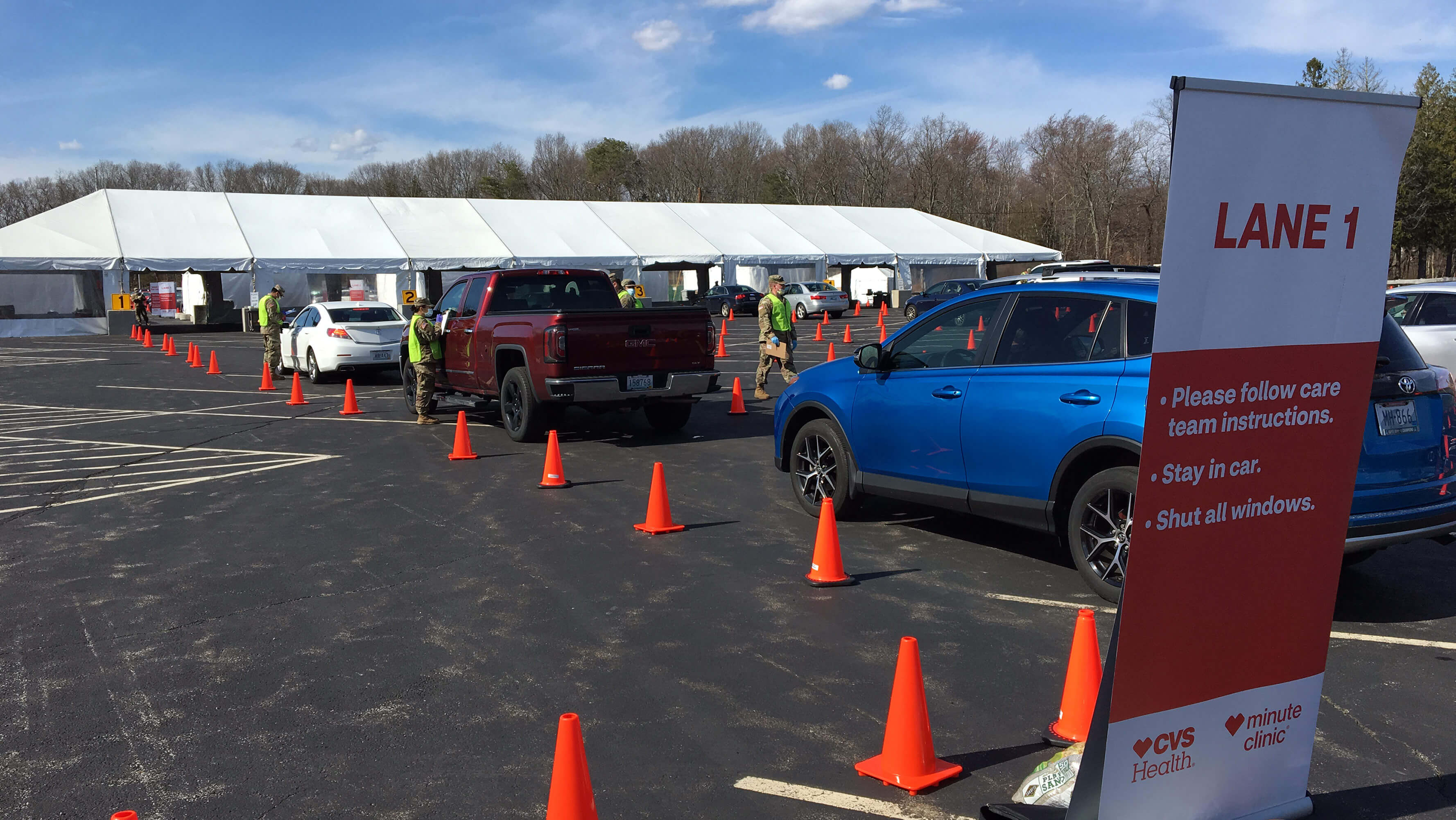 A line of cars queuing at a CVS Health rapid COVID-19 testing site.