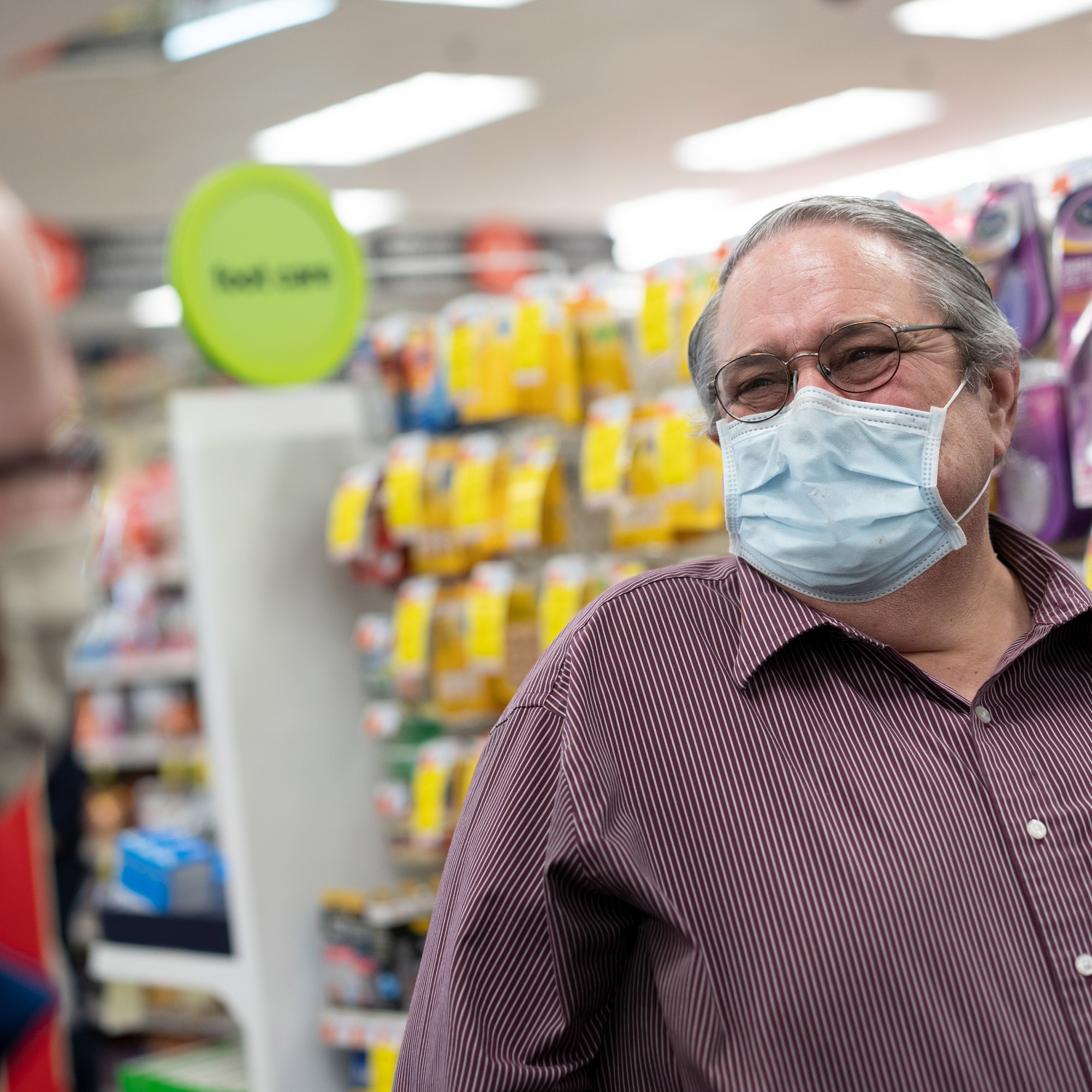 Steve Normandy and Dr. Ed Colozzi talk in a store aisle of CVS Pharmacy.
