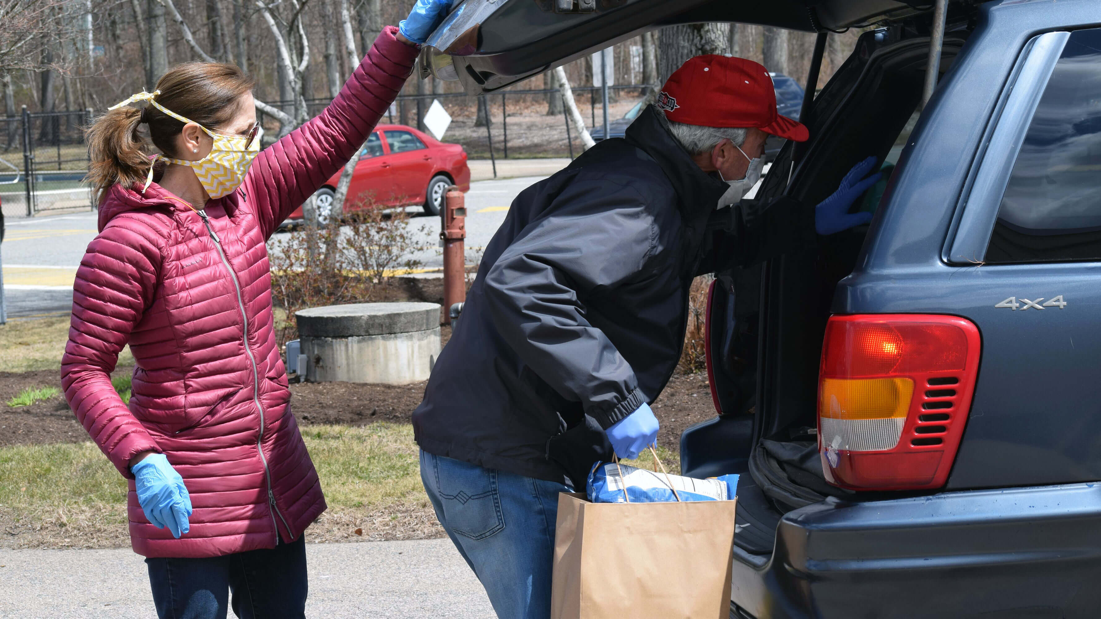 Hockomock area YMCA Board Chairman Mary Clermont and President Ed Hurley loading food into a vehicle.