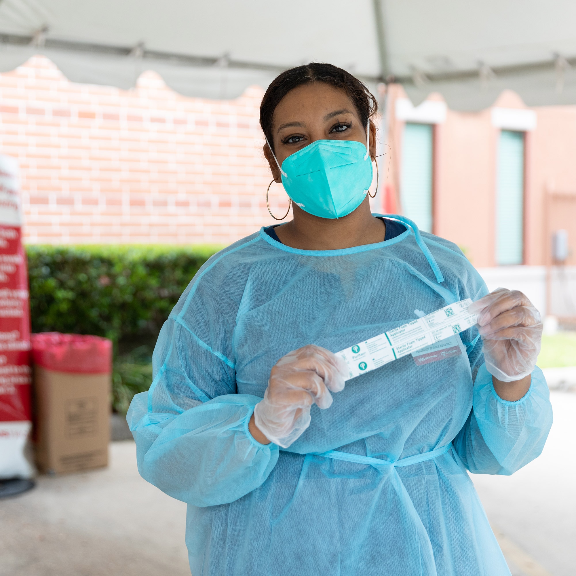 Alysses Goree standing at an outdoor CVS Health vaccination location.