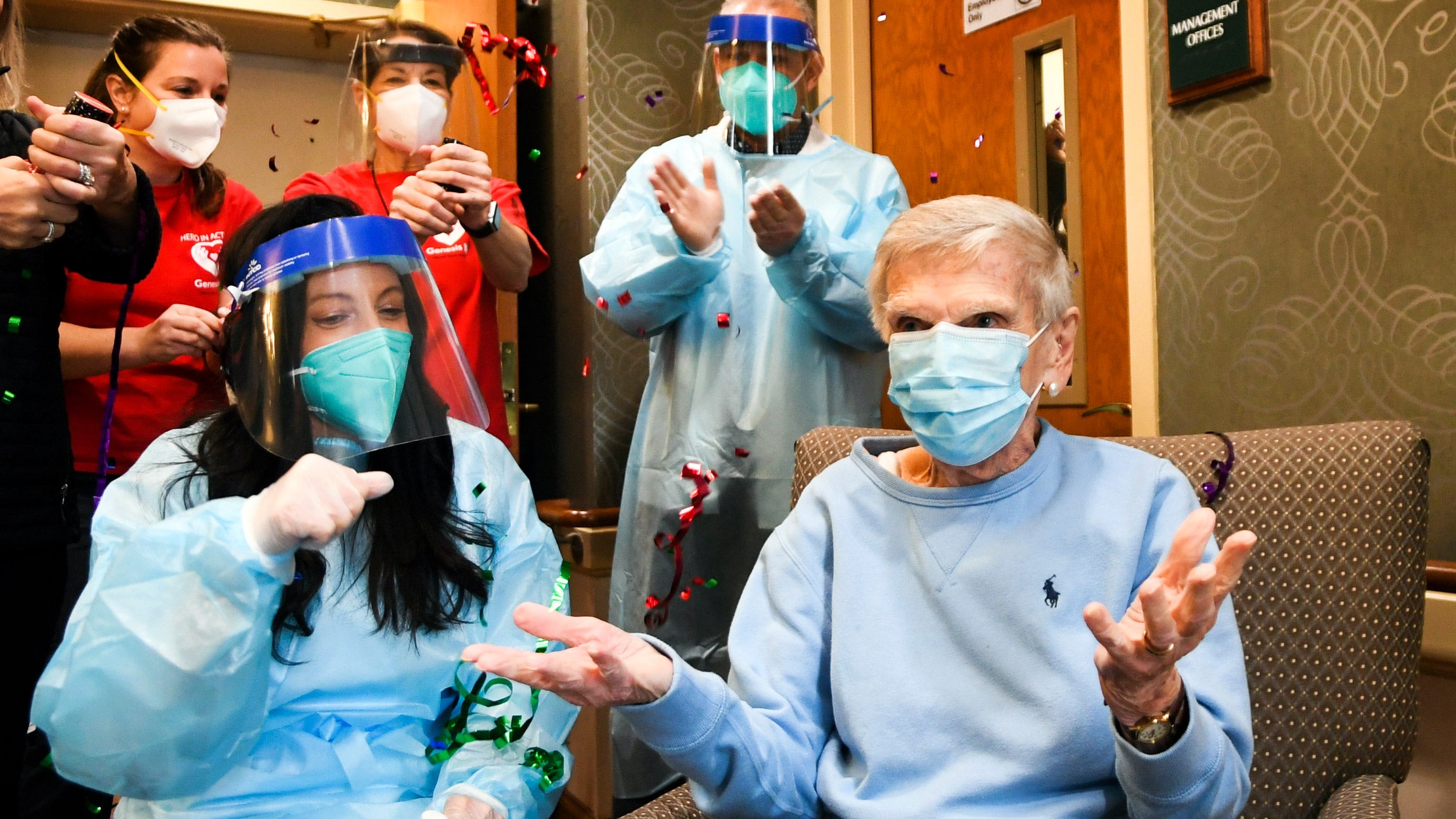 Staff and a resident, the first to receive a COVID-19 vaccine, celebrate at the Reservoir Skilled Nursing Facility in Connecticut.