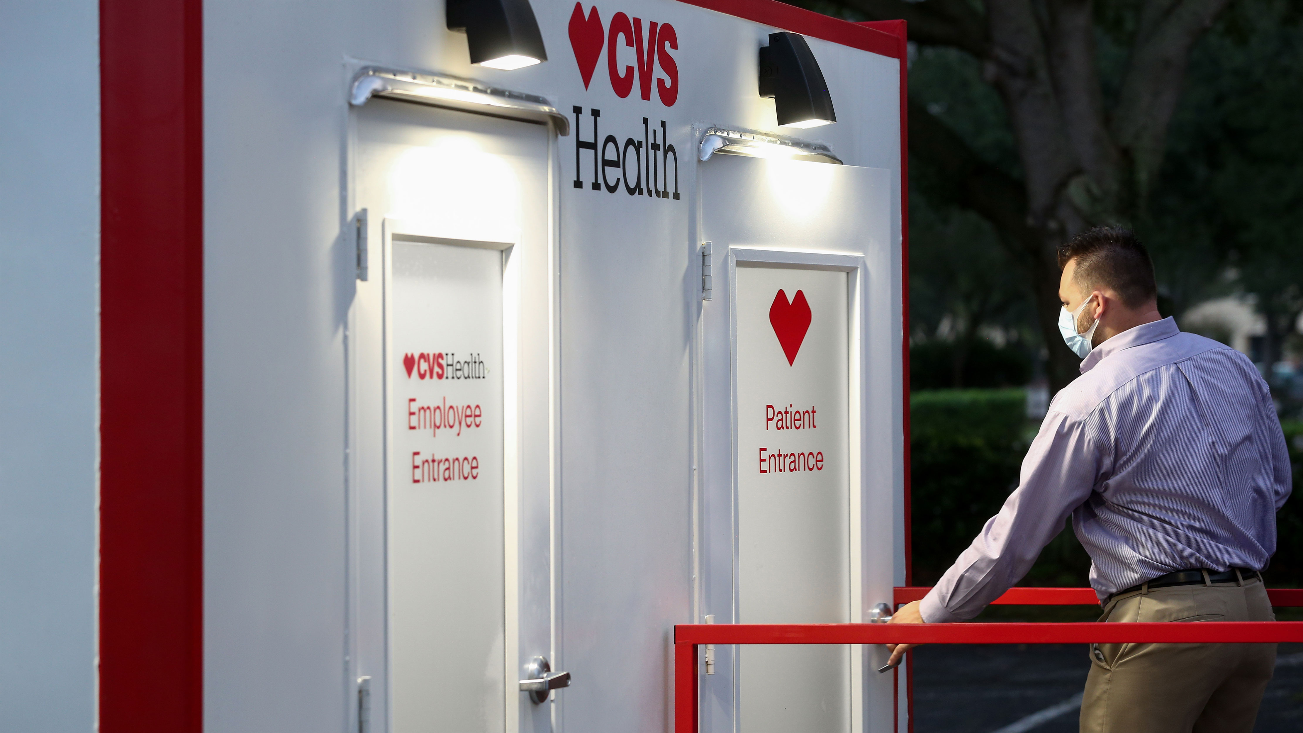 Man entering a CVS Health point of care testing site through the patient entrance of a kiosk.