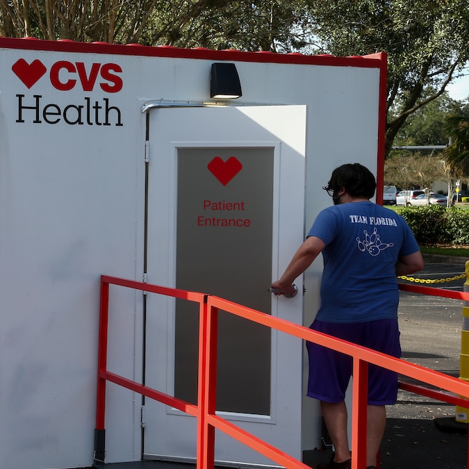 Man entering a CVS Health testing kiosk using the patient entrance door