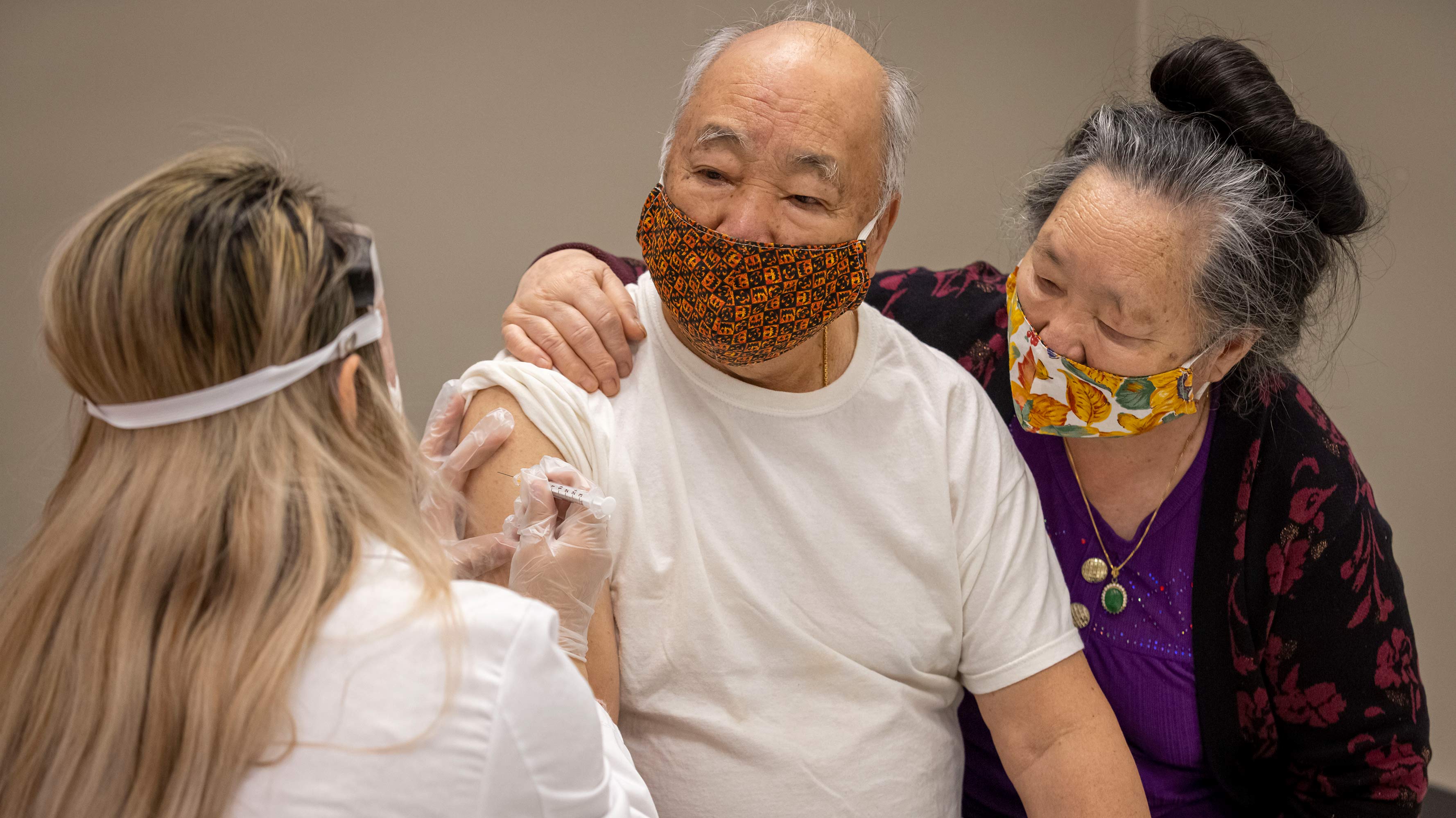 Zoua gave COVID-19 vaccinations to her grandparents Chue Lao and Chi Yang.