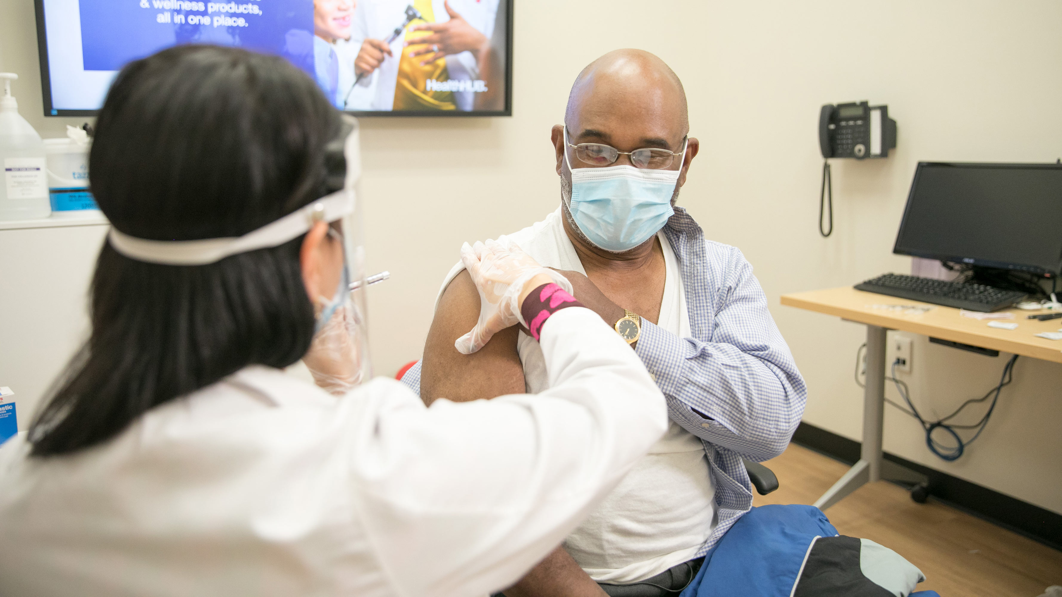 A man is seen receiving a vaccination at a CVS Pharmacy location.