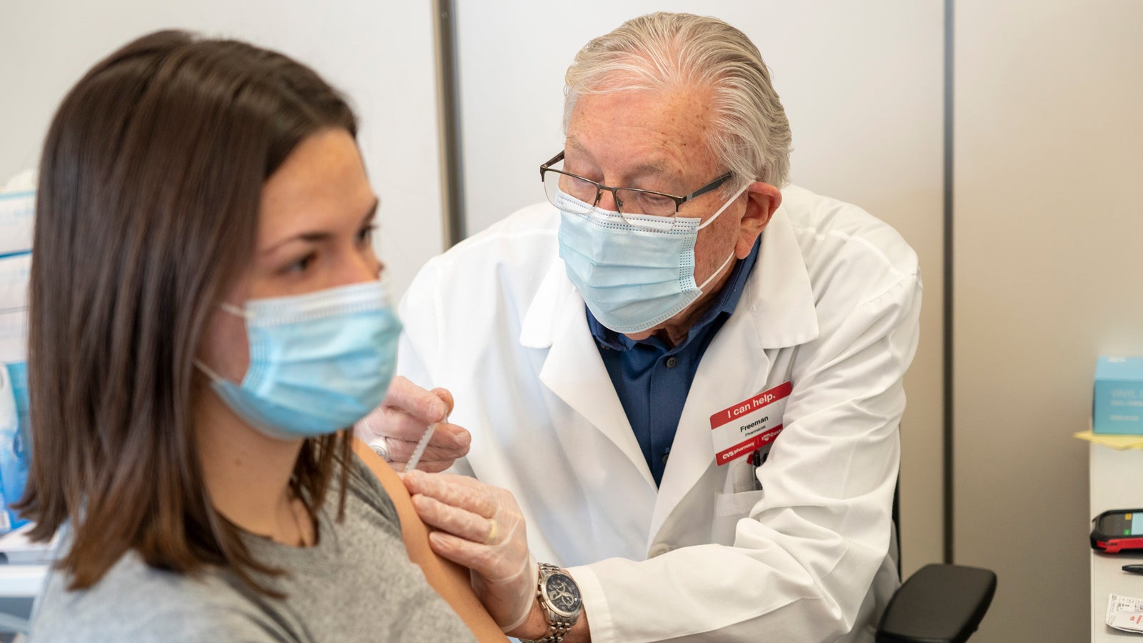 Dr. Freeman administering a vaccine to a patient.