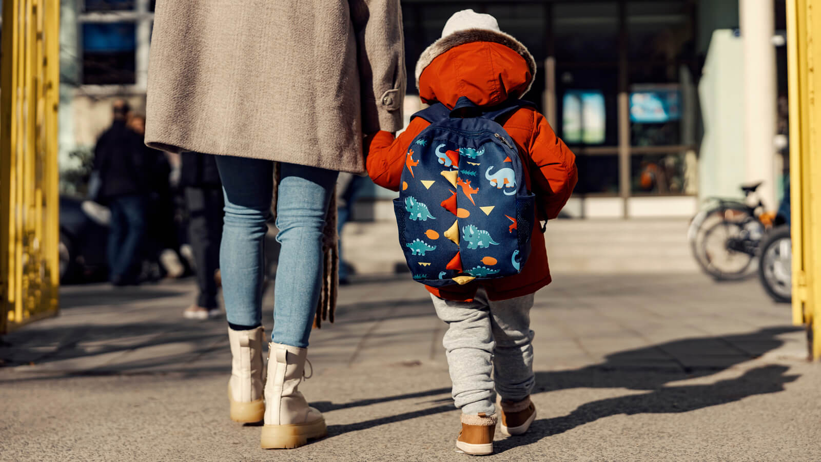 A mother walks her child into school.