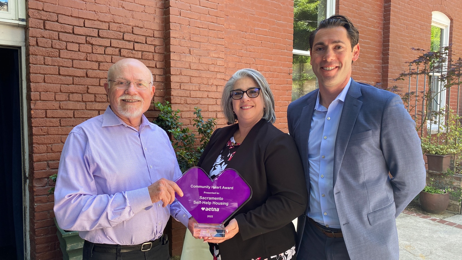 John Foley and Tahirih Kraft are presented with the Aetna Better Health of California’s Community Heart Award by Aaron Starfire of Aetna Better Health of California.