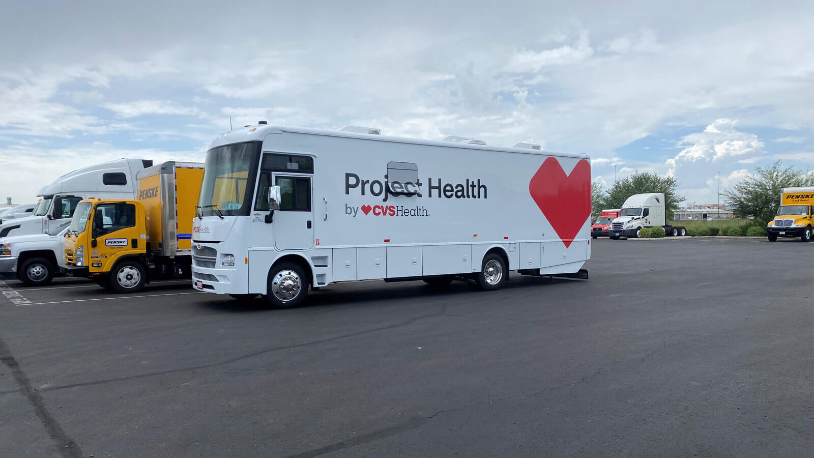 A Project Health screening bus parked in a lot.