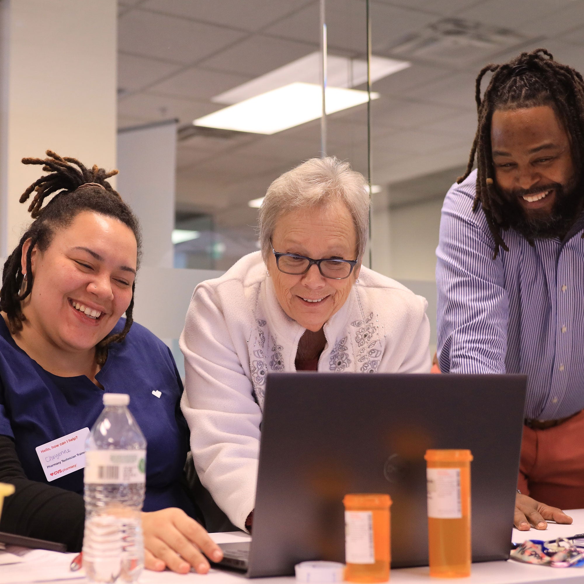Sean assists as pharmacy tech student, Cheyenne Woods, receives instruction from Shirley Laidley, Ebenezer Outreach Ministry, and a CVS Health colleague.