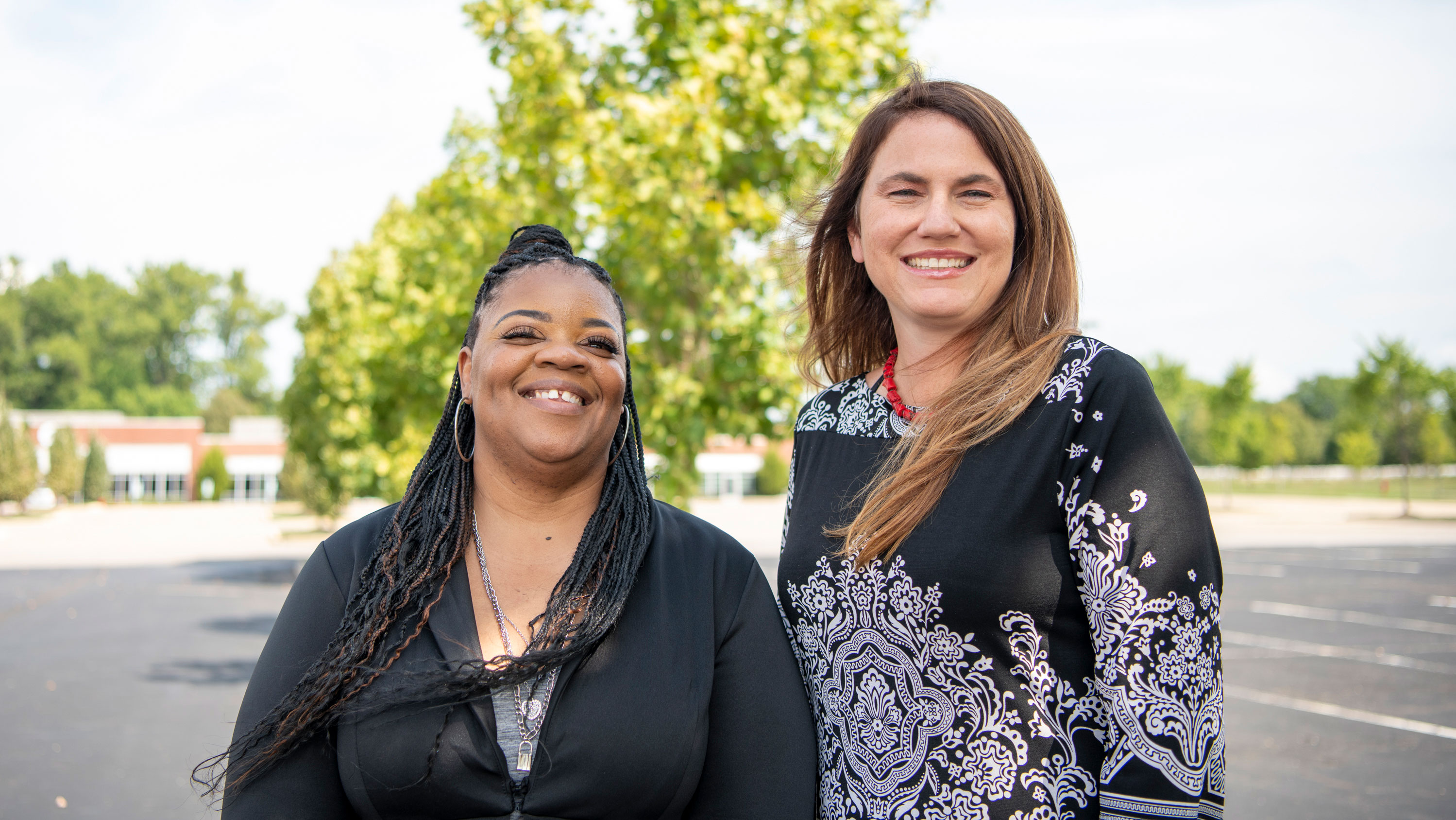 Medicare Case Manager Latisha Crum and Field Case Manager Anne Crutchman standing together outdoors smiling
