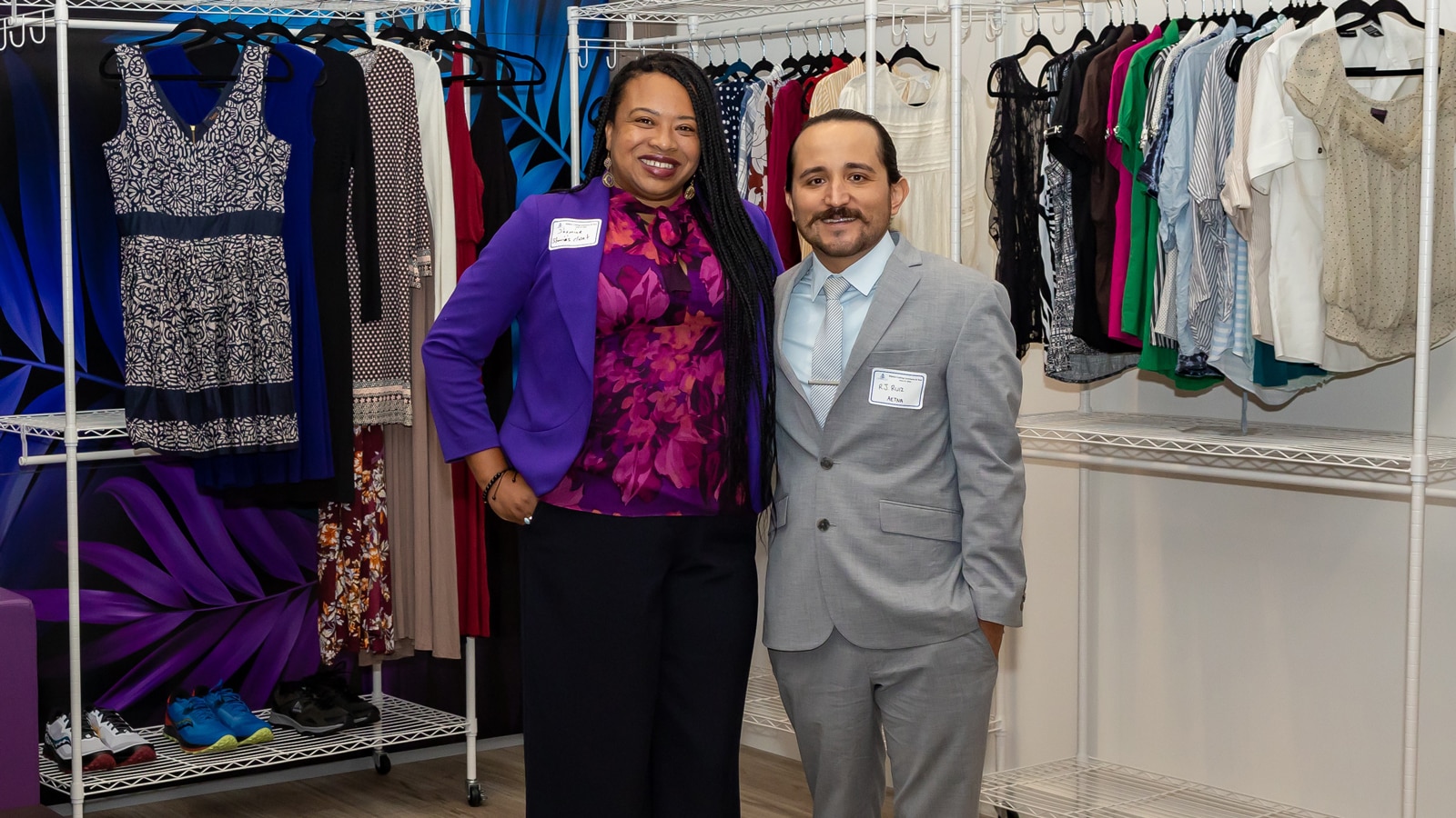 Shamine Linton, Founder and President of Sharia’s Closet and Robert J. Ruiz, Director of Health Care Quality Management, Aetna Better Health of California standing in a closet full of clothing.