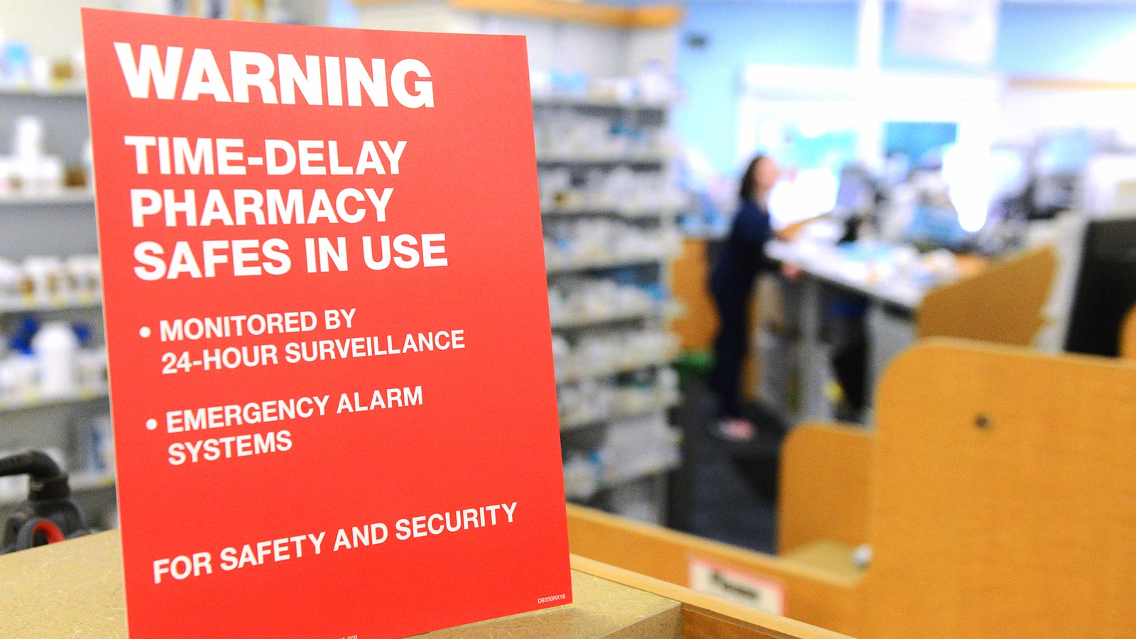 A sign warning of time-delay safes being used in a CVS Pharmacy