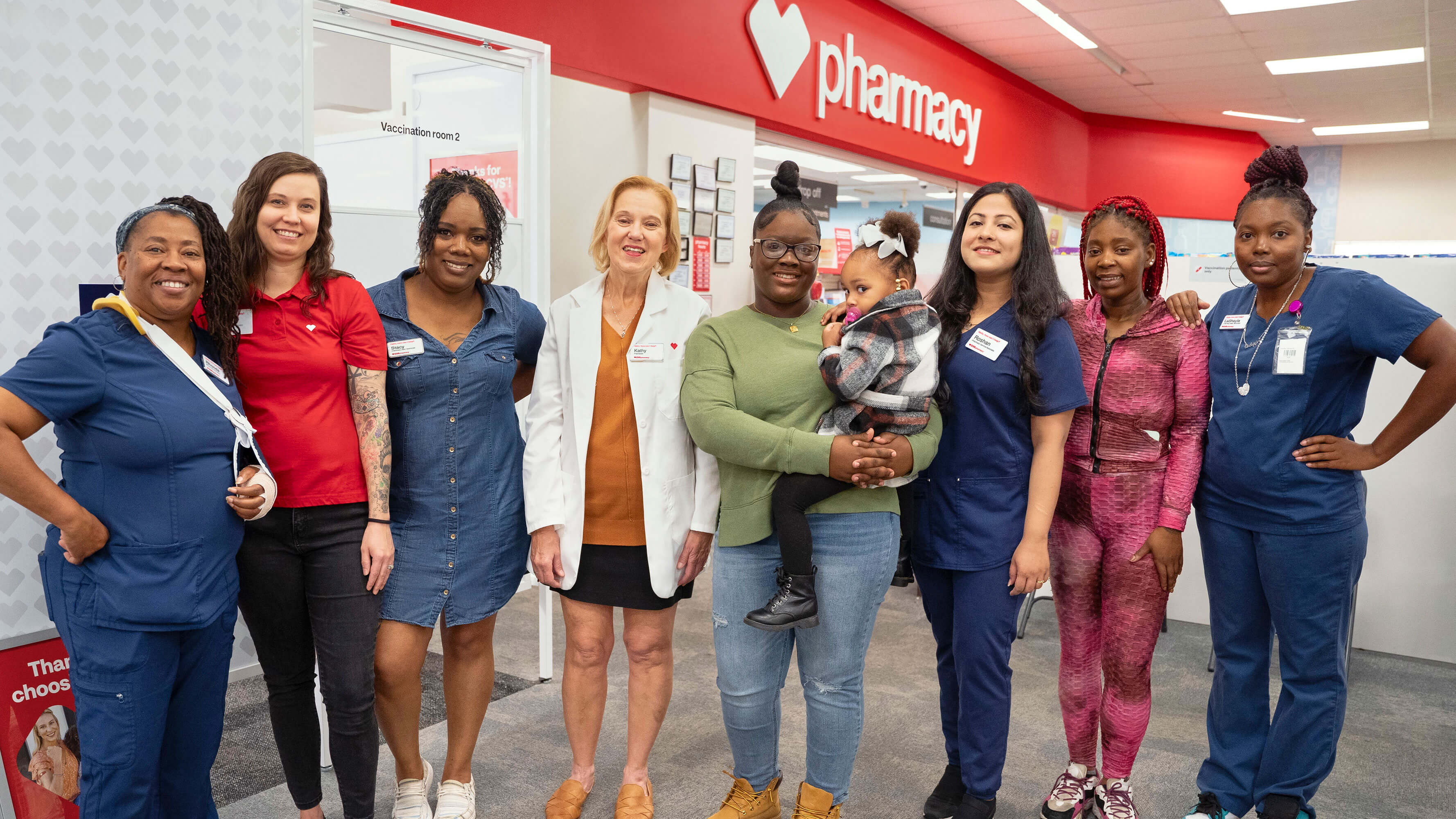 Shanquella Major holding her daughter Jayda pictured with the CVS Pharmacy staff that saved little Jayda's life. 