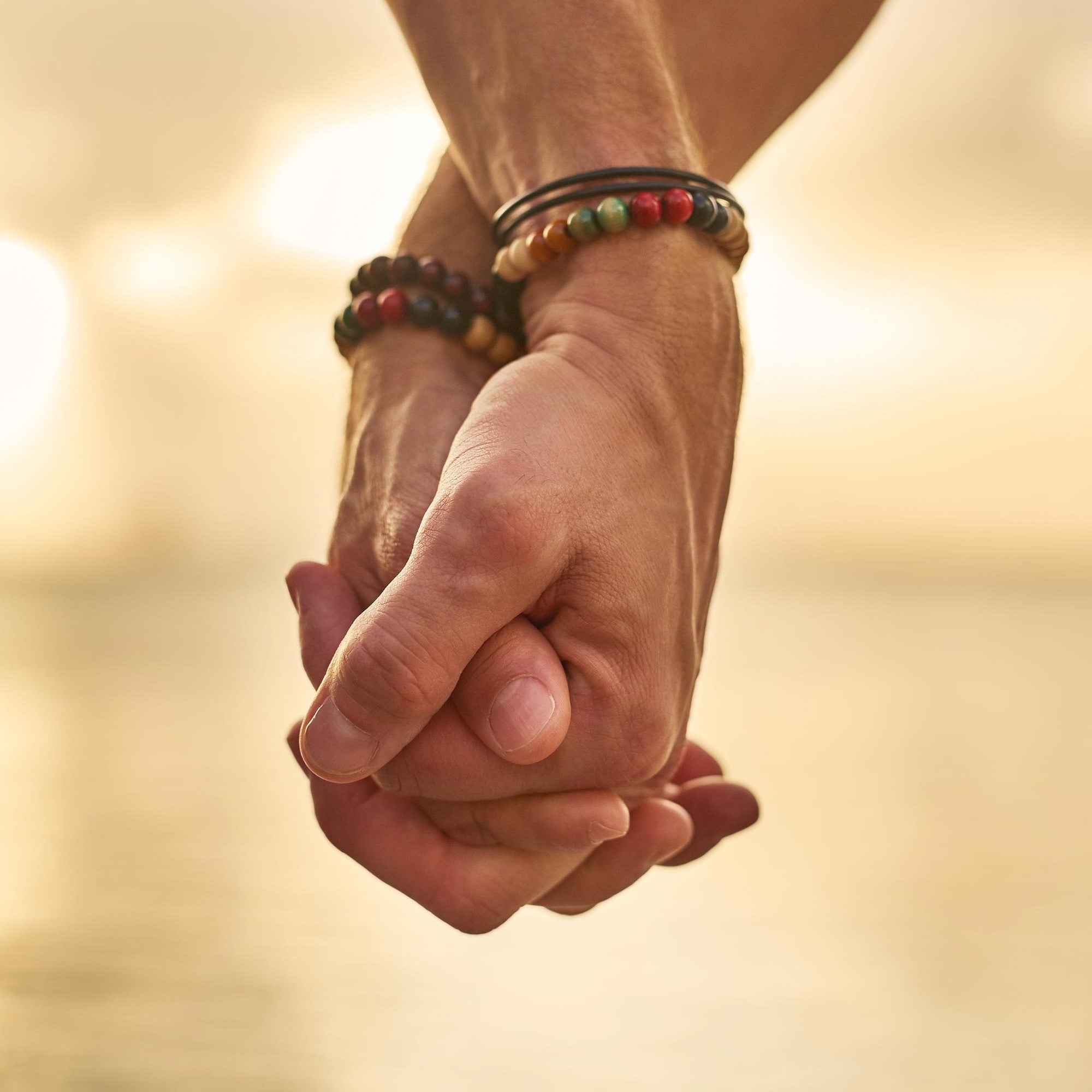 Two unknown subjects holding hands.